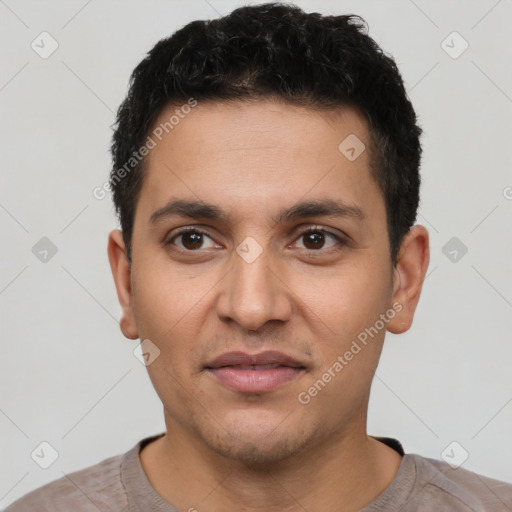 Joyful latino young-adult male with short  brown hair and brown eyes