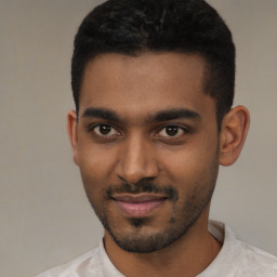 Joyful black young-adult male with short  black hair and brown eyes