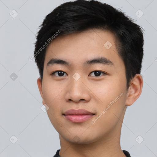 Joyful asian young-adult male with short  black hair and brown eyes