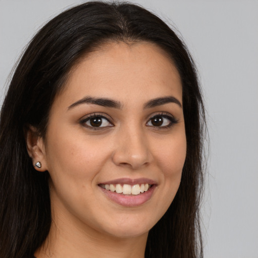 Joyful white young-adult female with long  brown hair and brown eyes