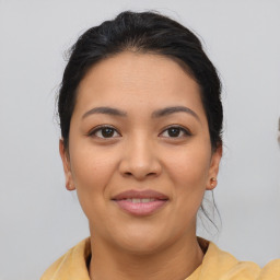 Joyful latino young-adult female with medium  brown hair and brown eyes