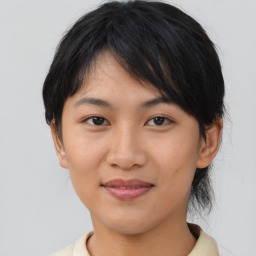 Joyful asian young-adult female with medium  brown hair and brown eyes