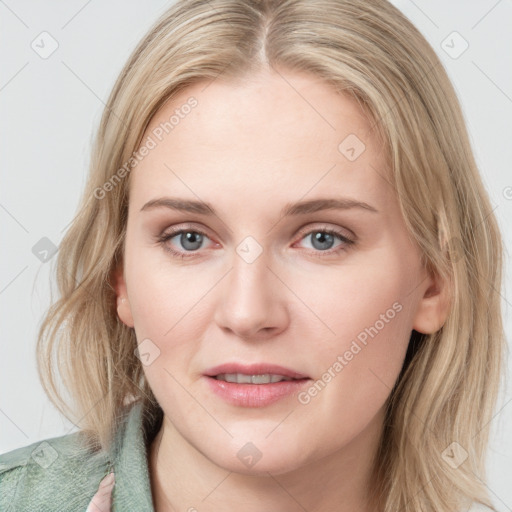 Joyful white young-adult female with long  brown hair and blue eyes