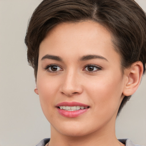 Joyful white young-adult female with short  brown hair and brown eyes