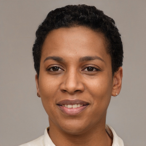 Joyful black young-adult female with short  black hair and brown eyes