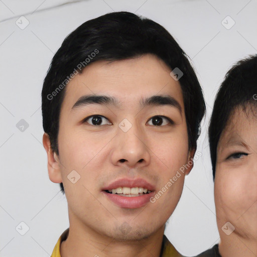 Joyful asian young-adult male with short  black hair and brown eyes