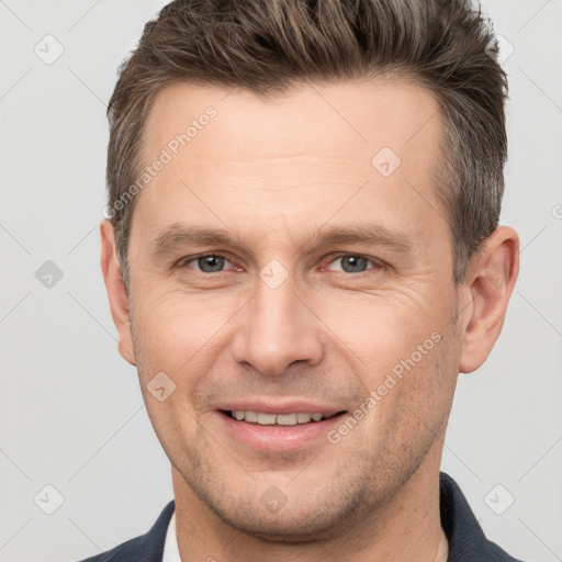 Joyful white adult male with short  brown hair and brown eyes