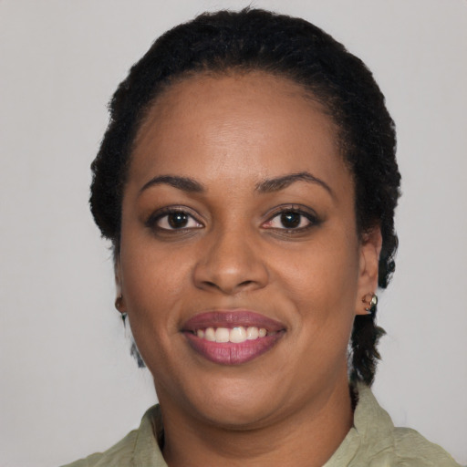 Joyful black adult female with short  black hair and brown eyes