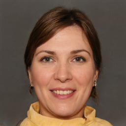 Joyful white adult female with medium  brown hair and brown eyes