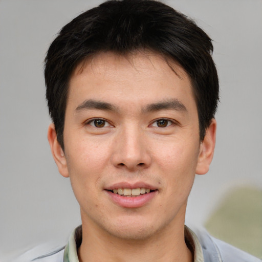 Joyful asian young-adult male with short  brown hair and brown eyes