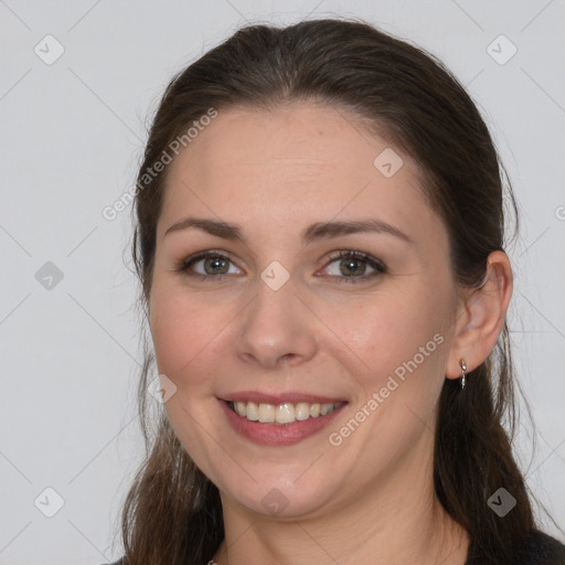 Joyful white young-adult female with long  brown hair and brown eyes