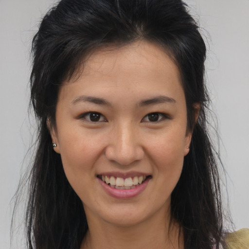 Joyful asian young-adult female with medium  brown hair and brown eyes