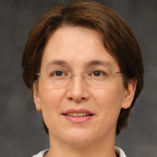 Joyful white adult female with medium  brown hair and green eyes