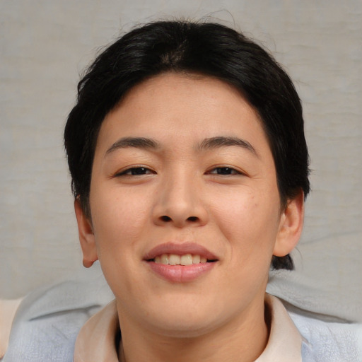 Joyful asian young-adult female with short  brown hair and brown eyes