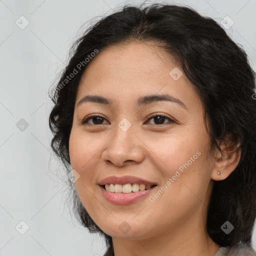 Joyful latino young-adult female with medium  brown hair and brown eyes