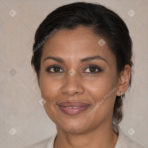 Joyful black adult female with medium  brown hair and brown eyes