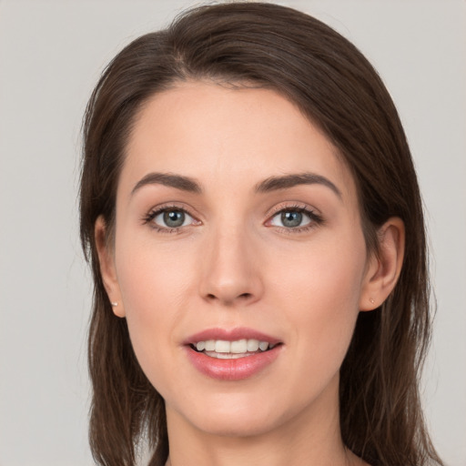 Joyful white young-adult female with long  brown hair and brown eyes