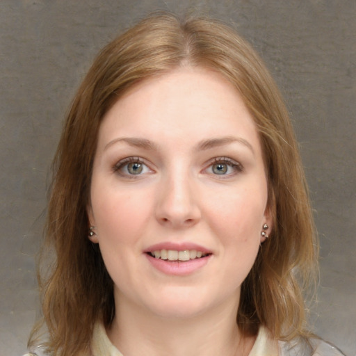 Joyful white young-adult female with medium  brown hair and grey eyes