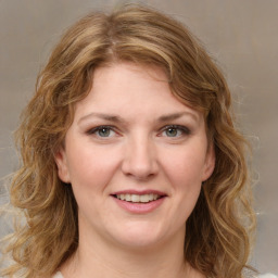 Joyful white young-adult female with medium  brown hair and green eyes