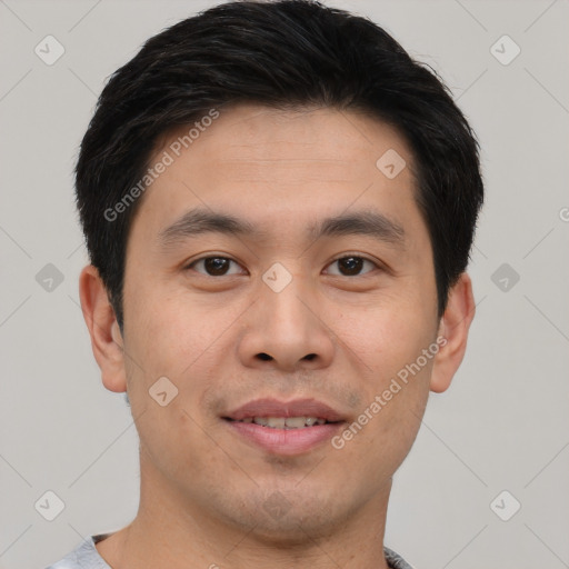 Joyful asian young-adult male with short  black hair and brown eyes