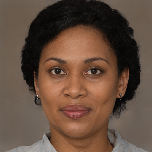 Joyful black adult female with short  brown hair and brown eyes