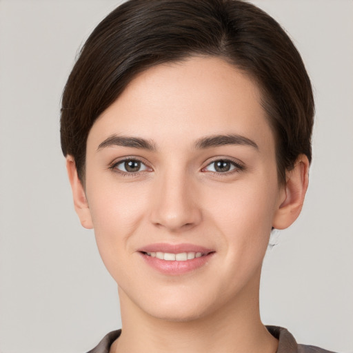 Joyful white young-adult female with short  brown hair and brown eyes