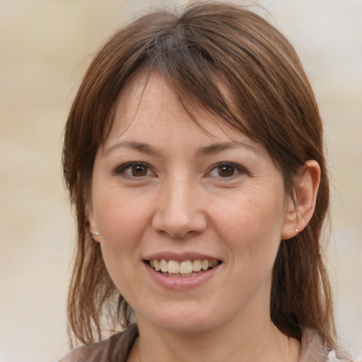 Joyful white adult female with medium  brown hair and brown eyes