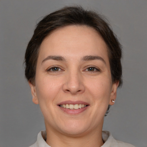 Joyful white adult female with short  brown hair and brown eyes