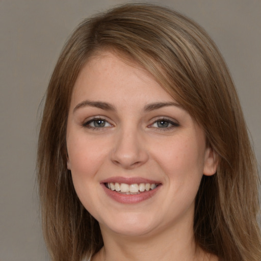 Joyful white young-adult female with long  brown hair and grey eyes