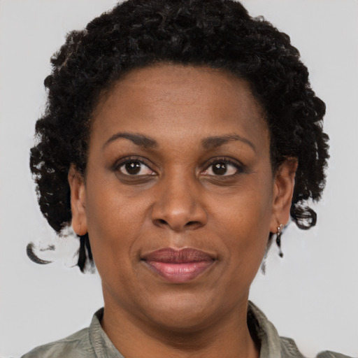Joyful black adult female with short  brown hair and brown eyes