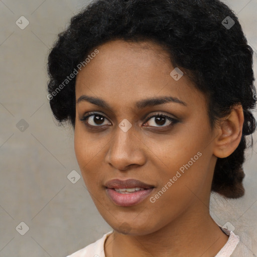 Joyful black young-adult female with short  black hair and brown eyes