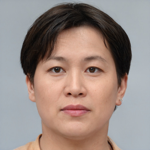 Joyful asian young-adult female with short  brown hair and brown eyes