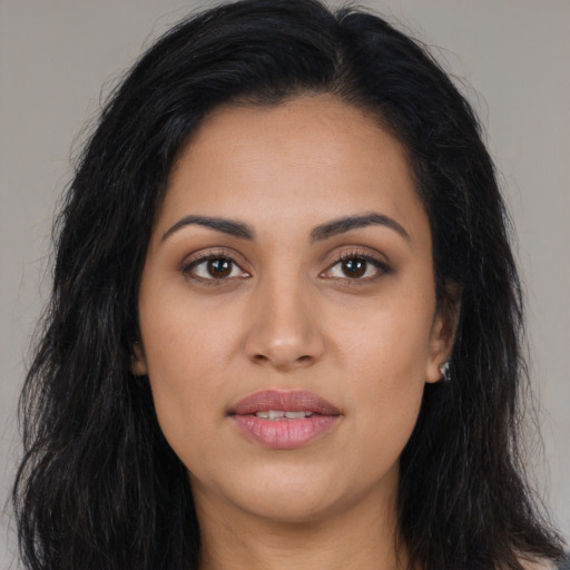 Joyful latino young-adult female with long  black hair and brown eyes
