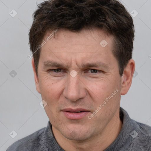 Joyful white adult male with short  brown hair and grey eyes