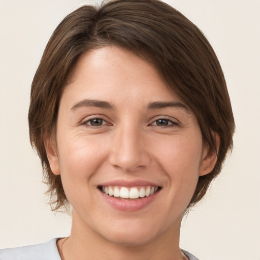 Joyful white young-adult female with medium  brown hair and brown eyes