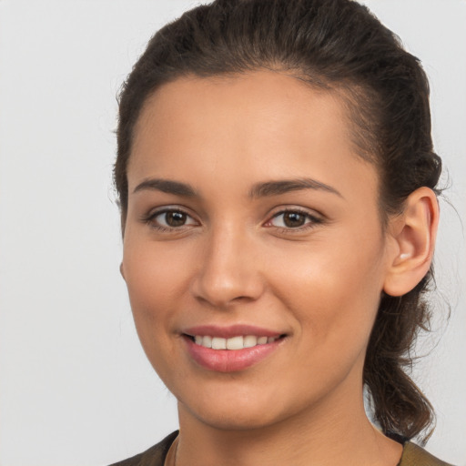 Joyful white young-adult female with long  brown hair and brown eyes