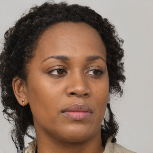 Neutral black young-adult female with medium  brown hair and brown eyes