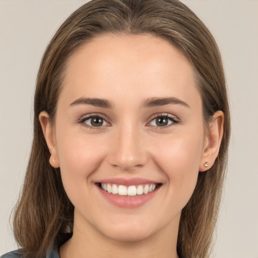 Joyful white young-adult female with long  brown hair and brown eyes