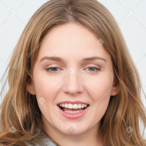 Joyful white young-adult female with long  brown hair and green eyes