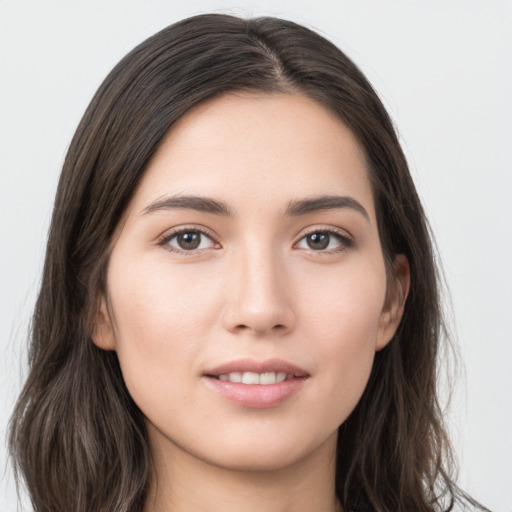 Joyful white young-adult female with long  brown hair and brown eyes