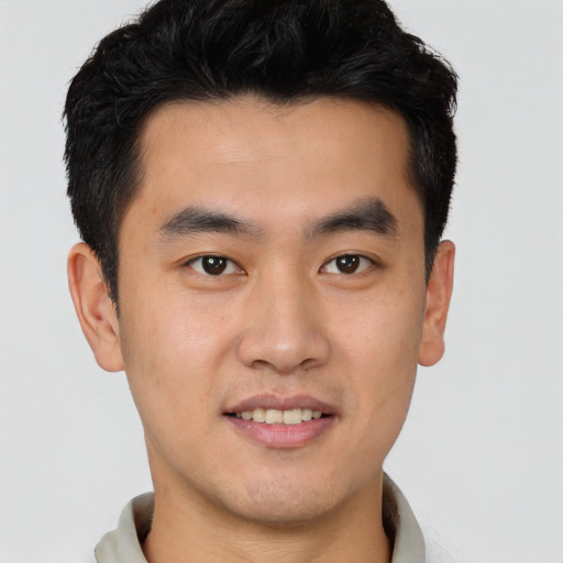 Joyful latino young-adult male with short  brown hair and brown eyes