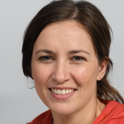 Joyful white adult female with medium  brown hair and brown eyes