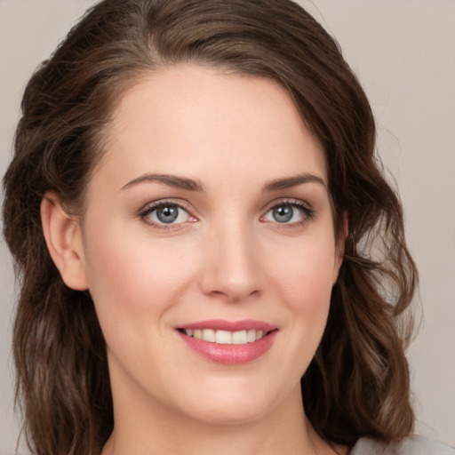 Joyful white young-adult female with medium  brown hair and green eyes