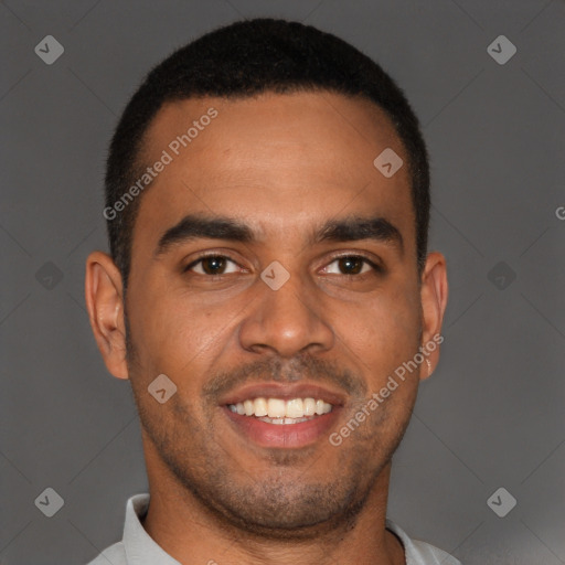 Joyful black young-adult male with short  brown hair and brown eyes