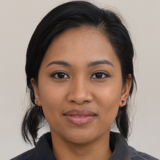 Joyful latino young-adult female with medium  black hair and brown eyes