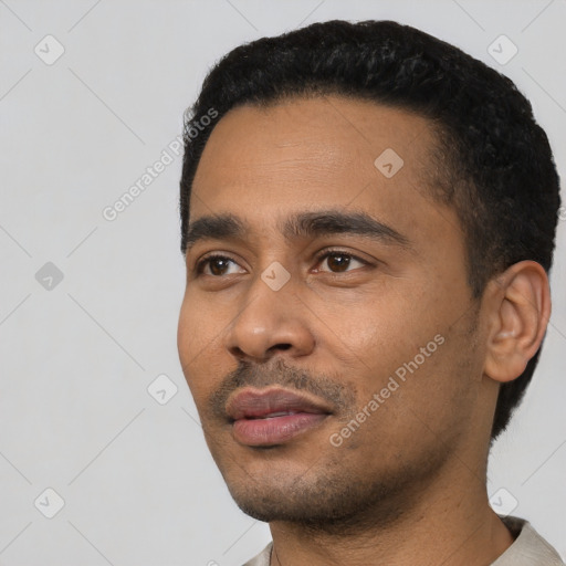 Neutral latino young-adult male with short  black hair and brown eyes
