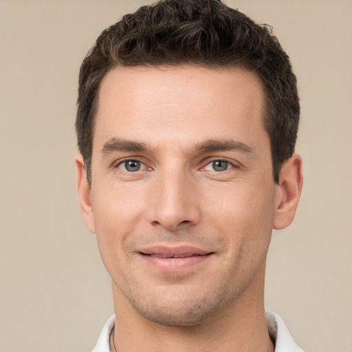 Joyful white young-adult male with short  brown hair and brown eyes