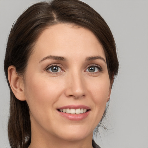 Joyful white young-adult female with medium  brown hair and brown eyes