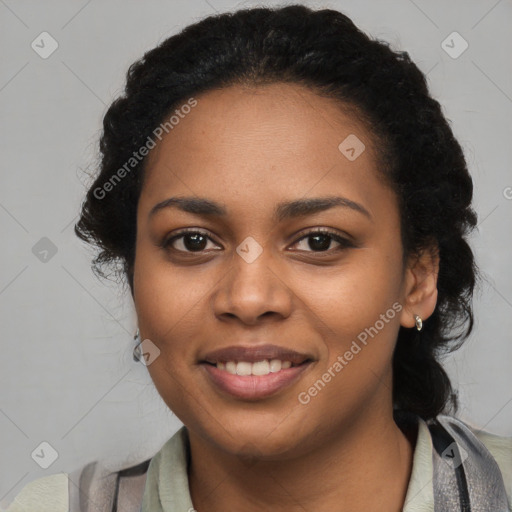 Joyful black young-adult female with long  black hair and brown eyes