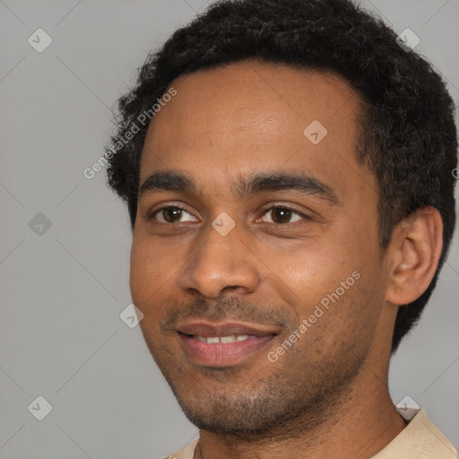 Joyful black young-adult male with short  black hair and brown eyes